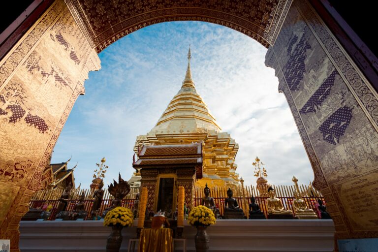 An arch leading into a temple with a sky in the background
